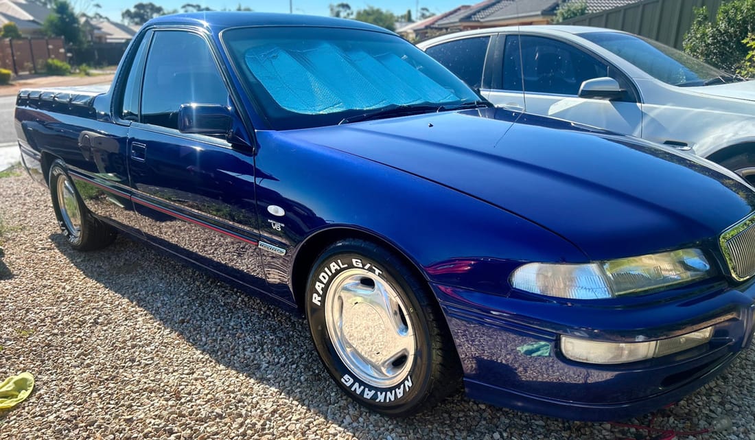 A dark blue Holden VS ute restored to a deep shine