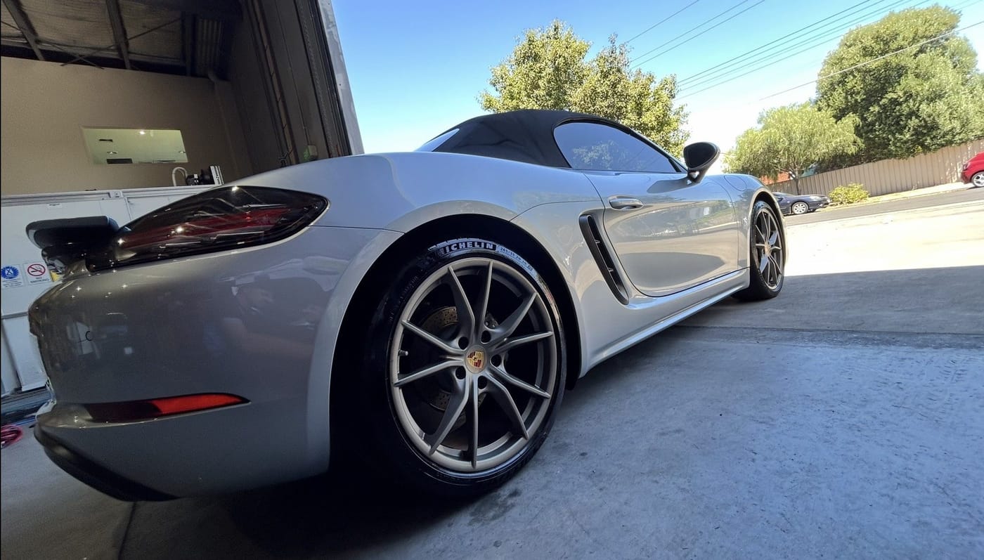 A silver Porsche convertible polished to a showroom finish